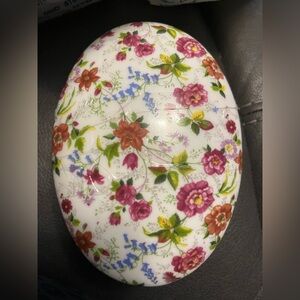 This is a Formalities by Baum Bros. porcelain floral chintz trinket box.